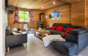 Lounge with sofas and fire place in chalet Snow Mountain