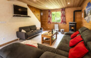 Lounge with sofas and fire place in chalet Snow Mountain
